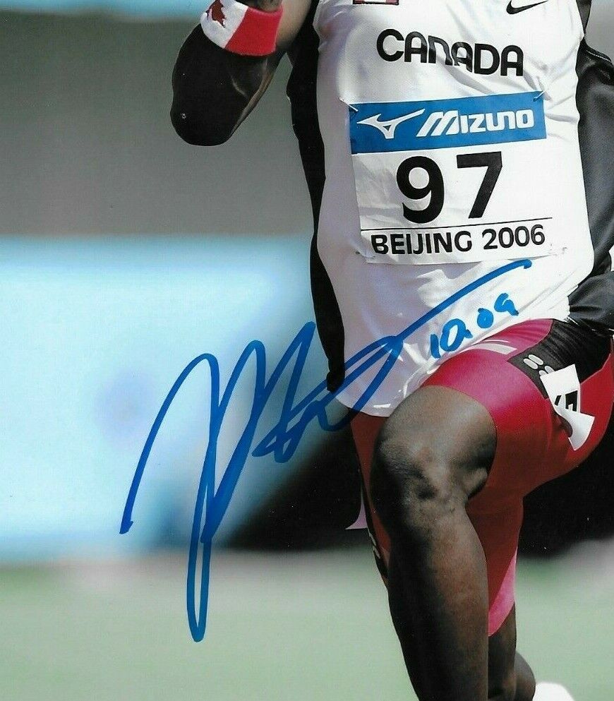 Photo originale autographiée de Justyn Warner sur 100 mètres d'athlétisme 8x10